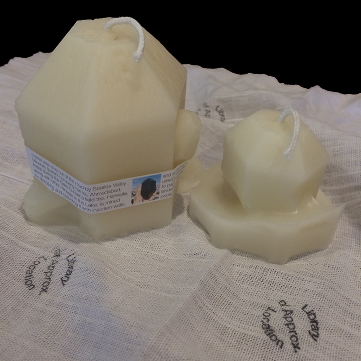 Two candles molded from hanksite crystals.