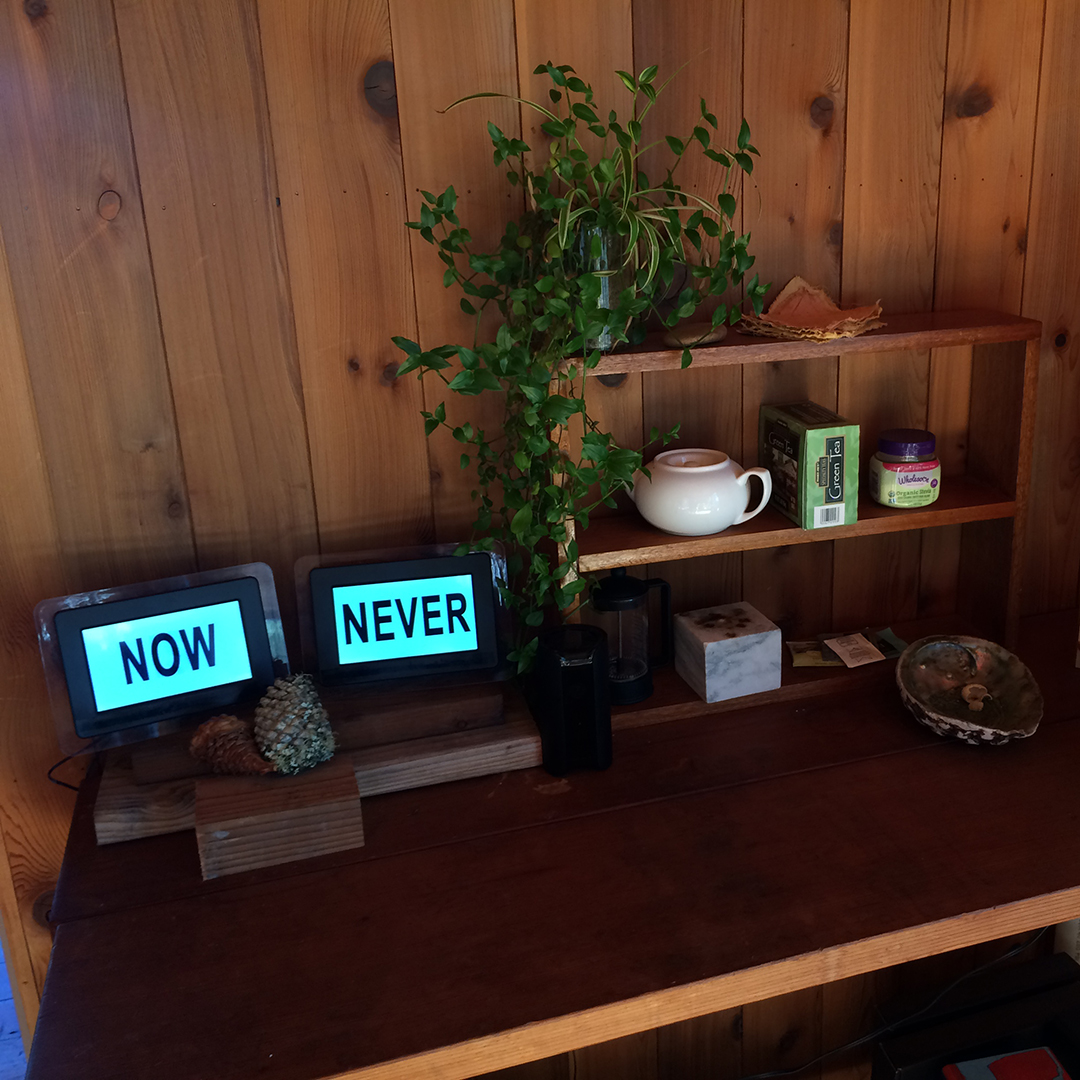 two screens on a table, one says never one says is